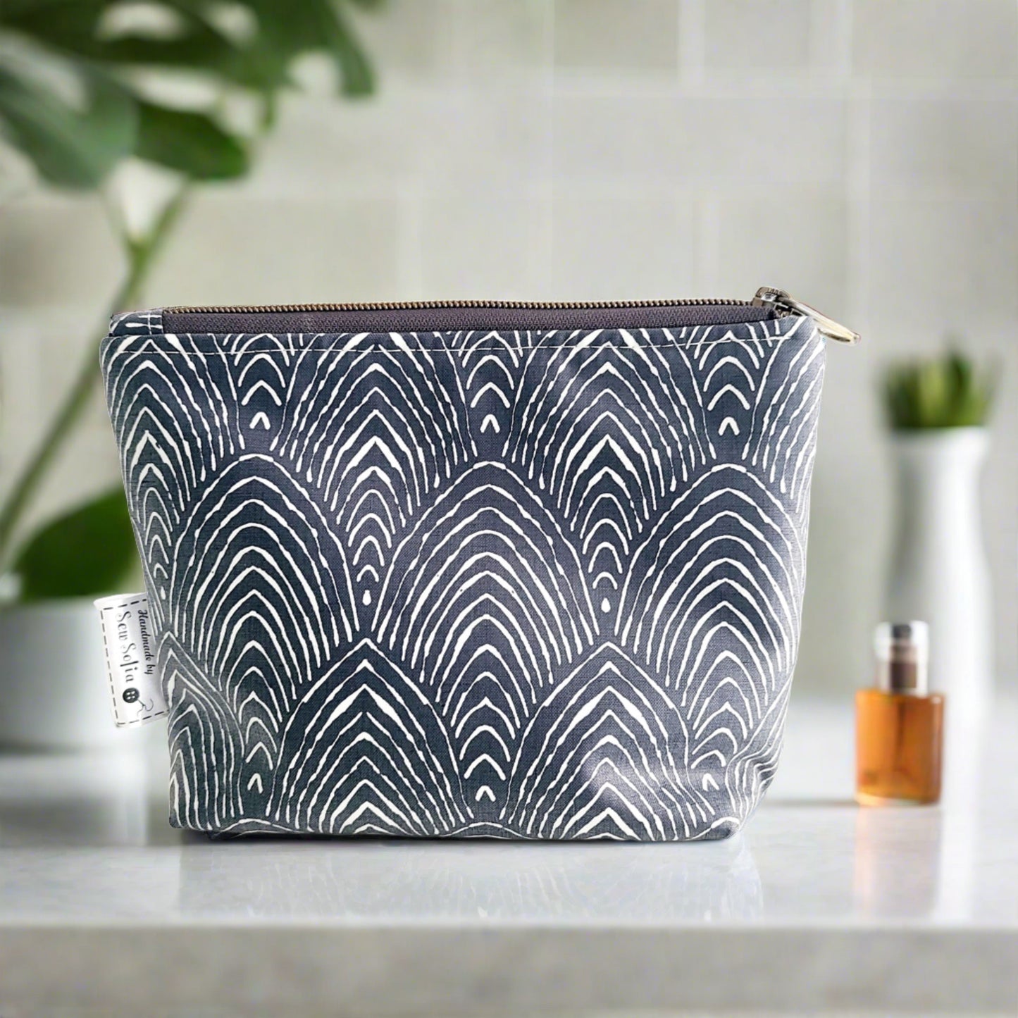 small padded navy waterproof bag with zip opening