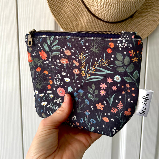 handmade padded make up pouch in wildflowers on a navy background