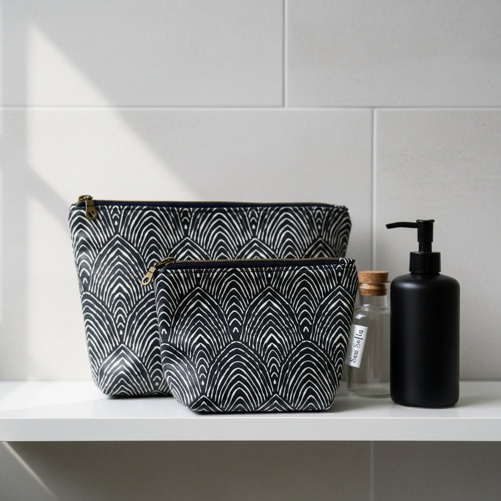 a set of small and medium sized unisex toiletry bags in a navy abstract design 